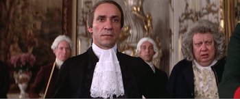 Movie still from “Amadeus” (1984), directed by Milos Forman – A man in a court robe and a judge in a court robe; Close Up shot, Low angle