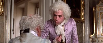Movie still from “Amadeus” (1984), directed by Milos Forman – A man in a wig looking in the mirror; Close Up shot, Over the shoulder angle