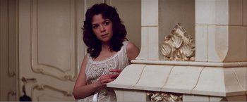 Movie still from “Amadeus” (1984), directed by Milos Forman – A woman in a white dress standing in front of a fireplace; Close Up shot, Low angle
