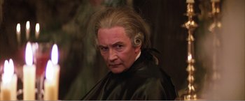 Movie still from “Amadeus” (1984), directed by Milos Forman – An old man with a long hair and a wig; Close Up shot, High angle