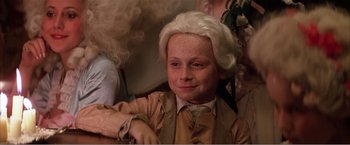 Movie still from “Amadeus” (1984), directed by Milos Forman – A young boy with a wig and a wig; Close Up shot, High angle
