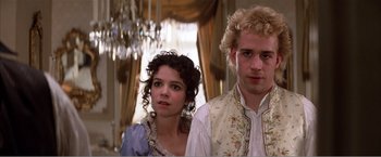 Movie still from “Amadeus” (1984), directed by Milos Forman – A man and a woman standing next to each other; Close Up shot, Low angle