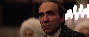 Movie still from “Amadeus” (1984), directed by Milos Forman – A person wearing a suit and tie; Close Up shot, Low angle