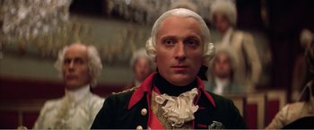 Movie still from “Amadeus” (1984), directed by Milos Forman – A person wearing a suit and a wig; Close Up shot, Low angle