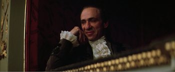 Movie still from “Amadeus” (1984), directed by Milos Forman – A person wearing a suit and tie; Close Up shot, Low angle