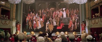 Movie still from “Amadeus” (1984), directed by Milos Forman – A group of people dressed in costumes on a stage; Extreme Wide shot, High angle