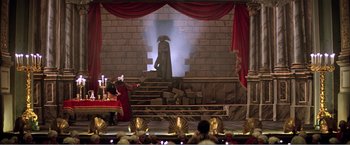 Movie still from “Amadeus” (1984), directed by Milos Forman – A scene of a stage with a man in a red robe; Extreme Wide shot, High angle