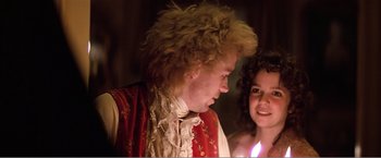 Movie still from “Amadeus” (1984), directed by Milos Forman – A man and a woman are dressed in period garb; Close Up shot, Over the shoulder angle