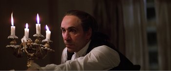 Movie still from “Amadeus” (1984), directed by Milos Forman – A man sitting in front of a lit candle; Close Up shot, Low angle