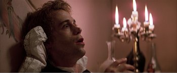 Movie still from “Amadeus” (1984), directed by Milos Forman – A young man is crying in front of a lit candle; Close Up shot, Low angle