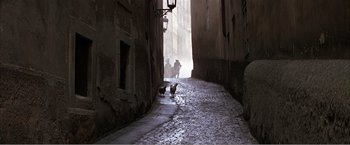 Movie still from “Amadeus” (1984), directed by Milos Forman – A couple of chickens walking down the middle of a street; Wide shot, High angle