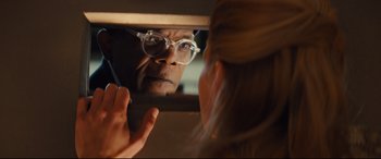 Movie still from “Kingsman: The Secret Service” (2014), directed by Matthew Vaughn – A man looking at a woman's reflection in a mirror; Close Up shot, Over the shoulder angle