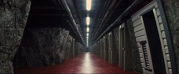 Movie still from “Kingsman: The Secret Service” (2014), directed by Matthew Vaughn – A long hallway in a building with many doors; Extreme Wide shot, High angle