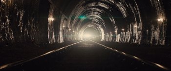 Movie still from “Kingsman: The Secret Service” (2014), directed by Matthew Vaughn – A train track with a light at the end of the tunnel; Extreme Wide shot, High angle