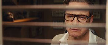 Movie still from “Kingsman: The Secret Service” (2014), directed by Matthew Vaughn – A man wearing glasses looking out a window; Close Up shot, Low angle