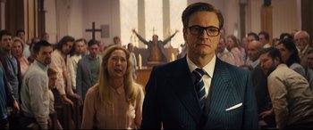 Movie still from “Kingsman: The Secret Service” (2014), directed by Matthew Vaughn – A man and a woman standing in front of a church; Medium shot, Low angle