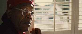 Movie still from “Kingsman: The Secret Service” (2014), directed by Matthew Vaughn – An older man wearing glasses looking out a window; Close Up shot, Low angle