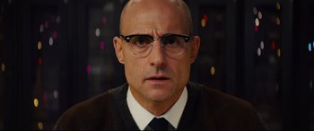 Movie still from “Kingsman: The Secret Service” (2014), directed by Matthew Vaughn – A bald man wearing glasses and a tie; Close Up shot, Low angle