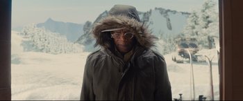Movie still from “Kingsman: The Secret Service” (2014), directed by Matthew Vaughn – An older man wearing a parka with a fur trimmed hood; Medium shot, Low angle