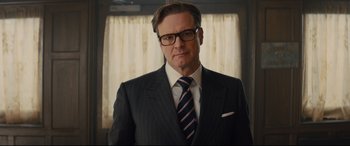 Movie still from “Kingsman: The Secret Service” (2014), directed by Matthew Vaughn – A person wearing a suit and tie; Close Up shot, Low angle