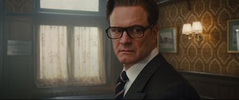 Movie still from “Kingsman: The Secret Service” (2014), directed by Matthew Vaughn – A person wearing a suit and tie; Close Up shot, Low angle