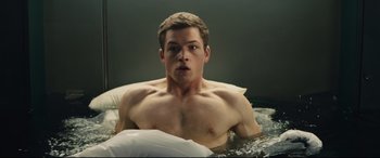 Movie still from “Kingsman: The Secret Service” (2014), directed by Matthew Vaughn – A man laying in a bed with a white pillow; Medium shot, High angle