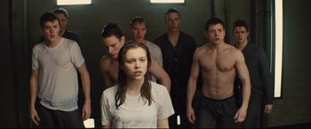 Movie still from “Kingsman: The Secret Service” (2014), directed by Matthew Vaughn – A group of young men standing next to a woman; Medium shot, High angle