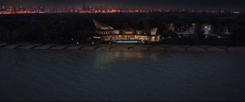 Movie still from “Kingsman: The Secret Service” (2014), directed by Matthew Vaughn – An aerial view of a building at night with lights on; Extreme Wide shot, High angle