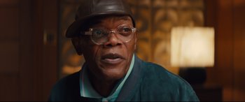 Movie still from “Kingsman: The Secret Service” (2014), directed by Matthew Vaughn – An older man wearing glasses and a hat; Close Up shot, Low angle