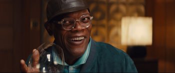 Movie still from “Kingsman: The Secret Service” (2014), directed by Matthew Vaughn – A person wearing glasses and a hat; Close Up shot, Low angle