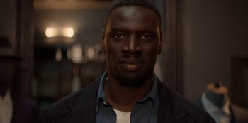 Movie still from “Lupin” (2021), created by Tigran Rosine – A person wearing a jacket; Close Up shot, Low angle