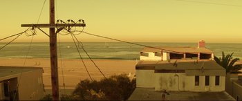 Movie still from “Magic Mike” (2012), directed by Steven Soderbergh – A view of the ocean from a deck at sunset; Extreme Wide shot, High angle