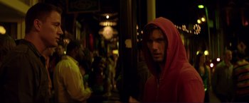Movie still from “Magic Mike” (2012), directed by Steven Soderbergh – A man in a red jacket standing in front of a crowd of onlookers; Close Up shot, Over the shoulder angle