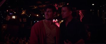 Movie still from “Magic Mike” (2012), directed by Steven Soderbergh – A couple of men standing next to each other; Medium shot, Over the shoulder angle