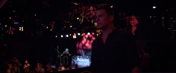 Movie still from “Magic Mike” (2012), directed by Steven Soderbergh – A man standing in front of a stage at night; Close Up shot, Low angle