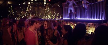 Movie still from “Magic Mike” (2012), directed by Steven Soderbergh – A group of young people standing in a room; Medium shot, Over the shoulder angle