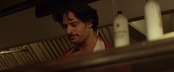 Movie still from “Magic Mike” (2012), directed by Steven Soderbergh – A person sitting at a table; Close Up shot, Over the shoulder angle