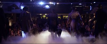 Movie still from “Magic Mike” (2012), directed by Steven Soderbergh – A group of men standing on a stage with smoke coming out of them; Wide shot, Low angle