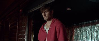 Movie still from “Magic Mike” (2012), directed by Steven Soderbergh – A man wearing a red jacket standing in a room; Close Up shot, Low angle