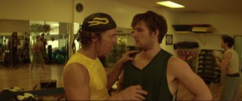 Movie still from “Magic Mike” (2012), directed by Steven Soderbergh – Two young men in a gym one of whom has his hand on the other's shoulder; Close Up shot, Over the shoulder angle