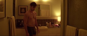 Movie still from “Magic Mike” (2012), directed by Steven Soderbergh – A man standing in front of a bathroom mirror; Medium shot, Over the shoulder angle
