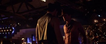 Movie still from “Magic Mike” (2012), directed by Steven Soderbergh – Two men in cowboy hats are standing next to each other; Medium shot, Over the shoulder angle