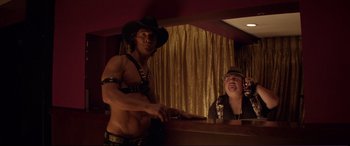 Movie still from “Magic Mike” (2012), directed by Steven Soderbergh – A man and a woman are standing at a bar; Medium shot, Over the shoulder angle