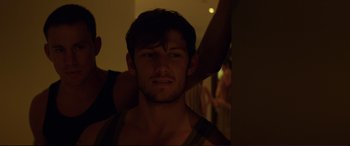 Movie still from “Magic Mike” (2012), directed by Steven Soderbergh – A young man with a beard is posing for the camera; Close Up shot, Over the shoulder angle