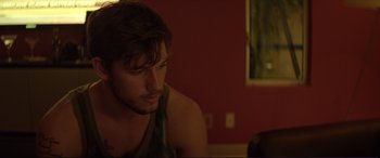 Movie still from “Magic Mike” (2012), directed by Steven Soderbergh – A person sitting in a room; Close Up shot, Over the shoulder angle