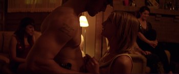 Movie still from “Magic Mike” (2012), directed by Steven Soderbergh – A man and a woman holding hands in a room; Medium shot, Low angle