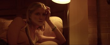 Movie still from “Magic Mike” (2012), directed by Steven Soderbergh – A beautiful young lady sitting in front of a lamp; Close Up shot, Low angle