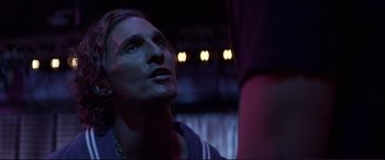 Movie still from “Magic Mike” (2012), directed by Steven Soderbergh – A man in a dark room looking into the distance; Close Up shot, Over the shoulder angle