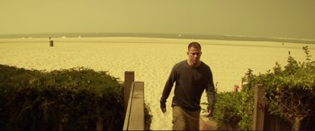 Movie still from “Magic Mike” (2012), directed by Steven Soderbergh – A man walking down the stairs on the beach; Wide shot, High angle