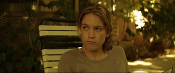 Movie still from “Magic Mike” (2012), directed by Steven Soderbergh – A woman sitting on top of a wooden bench; Close Up shot, Over the shoulder angle